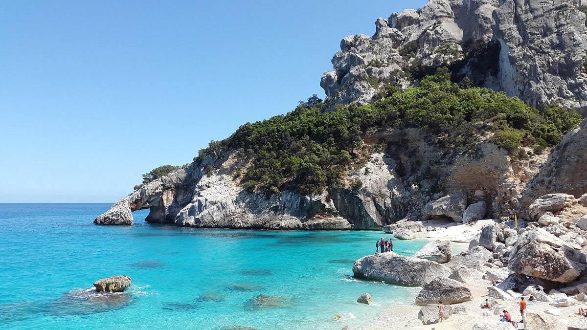 Aerial view of one of the top 10 beaches in Europe with turquoise waters, golden sands, and stunning coastal cliffs
