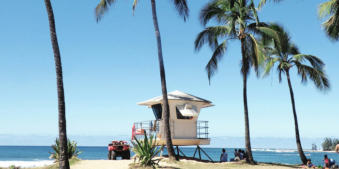 Aerial view of one of the top 10 beaches in the United States featuring clear turquoise water, white sand, and surrounding coastal landscapes.