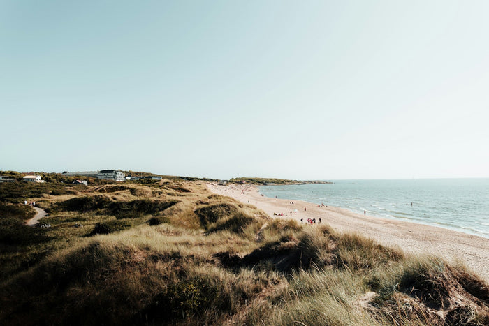 Aerial view of one of the top 10 beaches in Sweden with golden sand, blue water, and pine-lined coastline